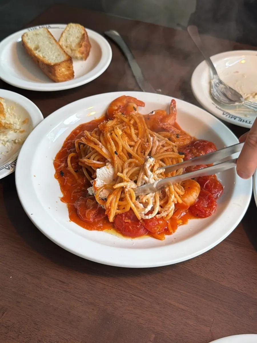 Pomodoro pasta topped with cherry tomatoes and shrimp