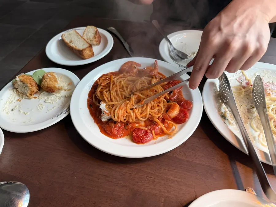 Wide shot of the pomodoro pasta topped with ricotta cheese