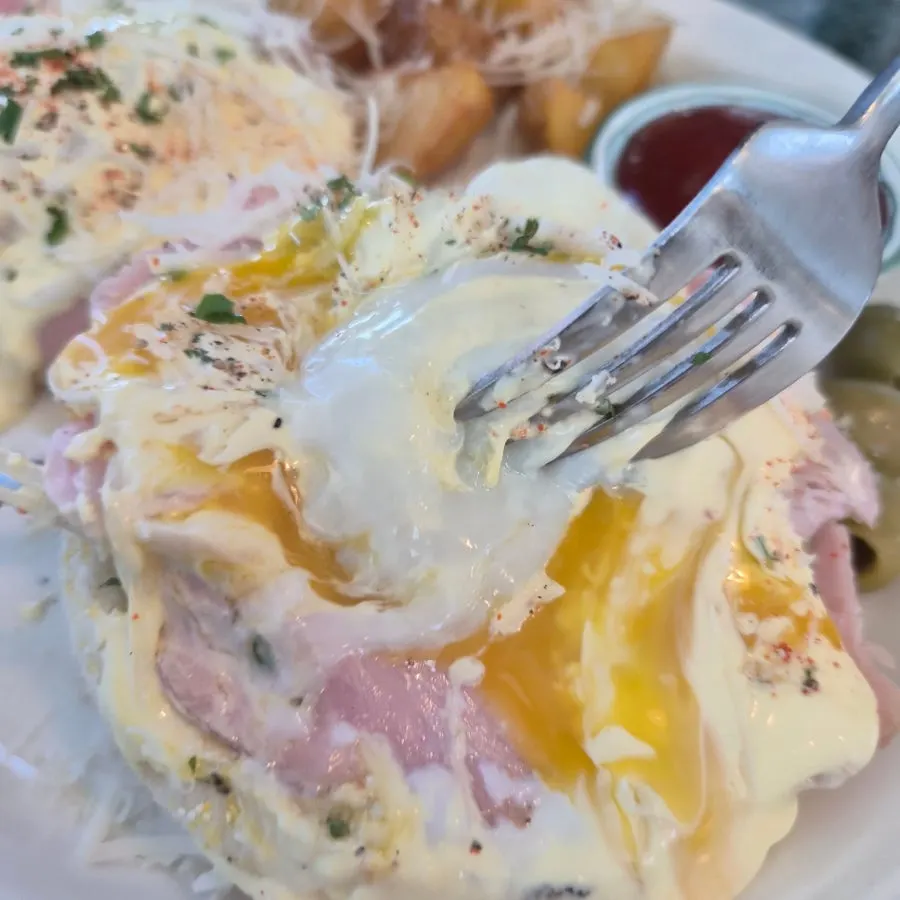 Close-up of the runny yolk on the egg Benedict