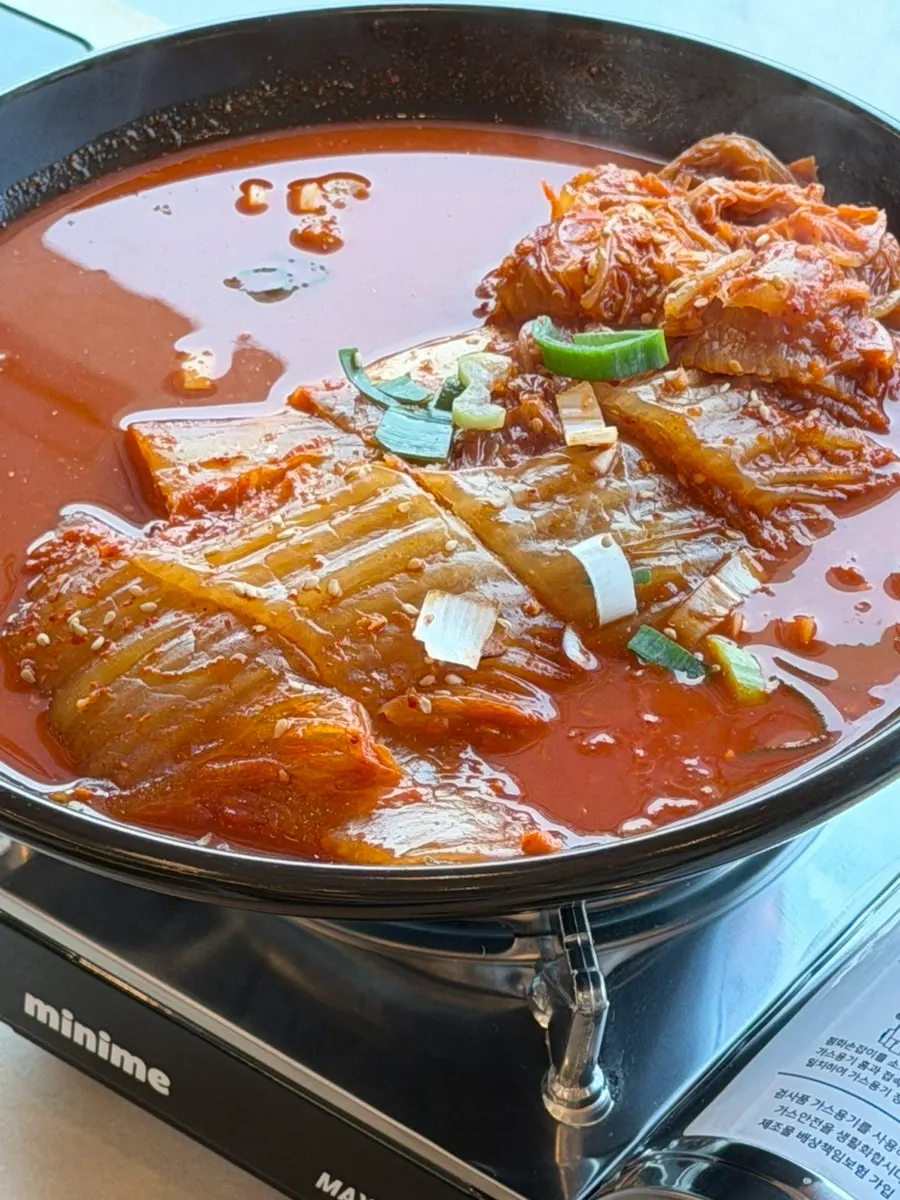 A bite of aged kimchi mackerel served with rice