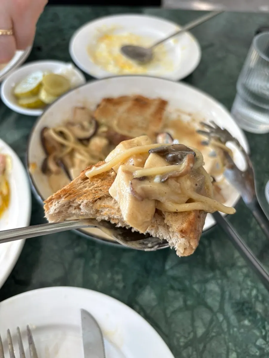 Eggs Benedict with olives and French fries