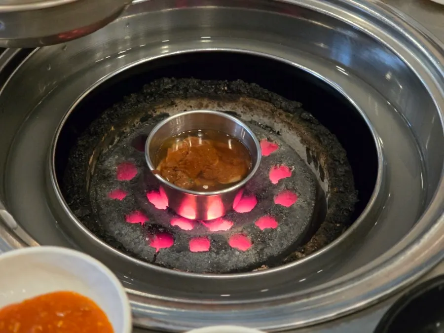 Small dish of myeolchi-jeot placed over the charcoal fire