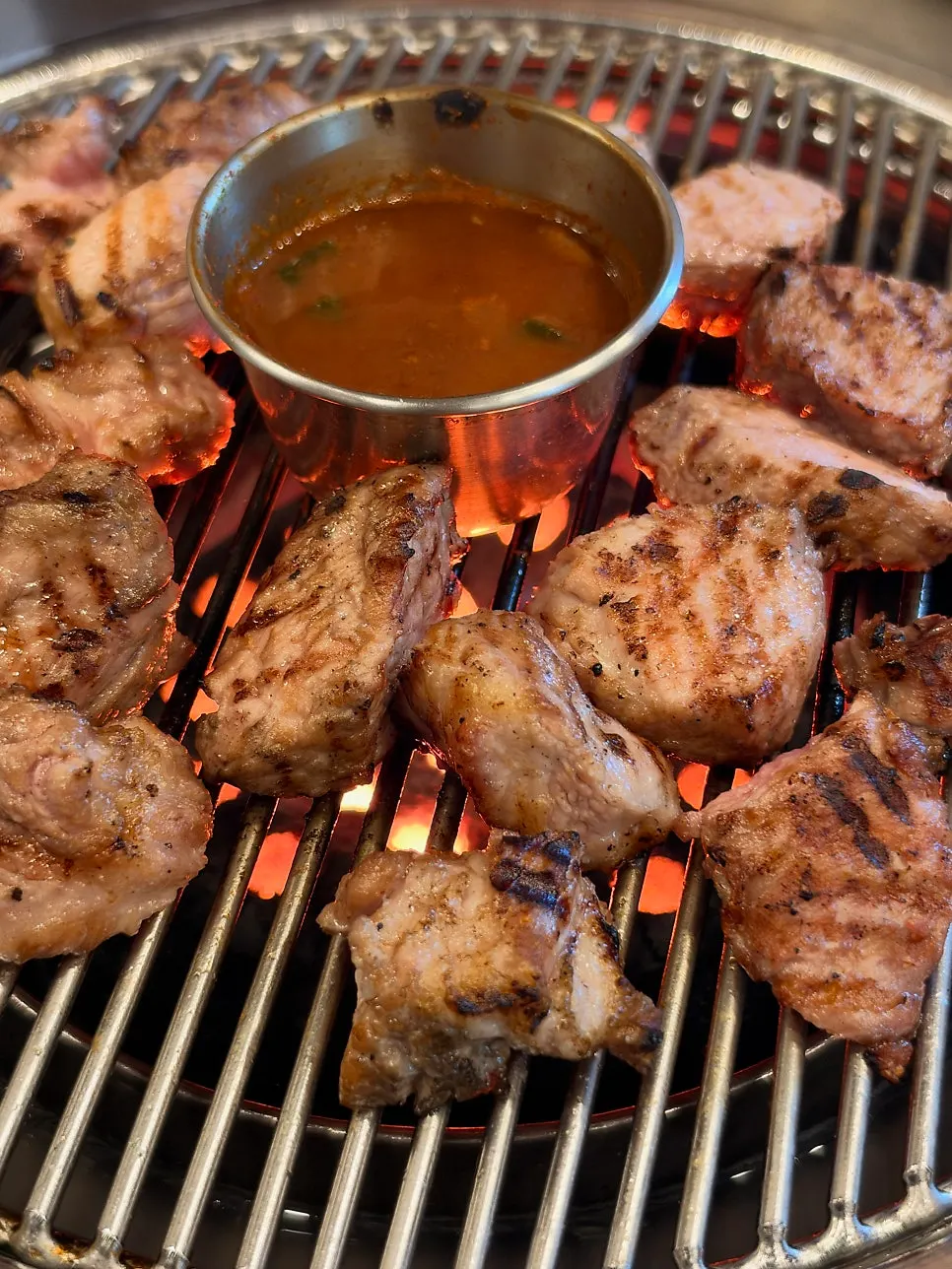 Pork neck placed on the charcoal grill