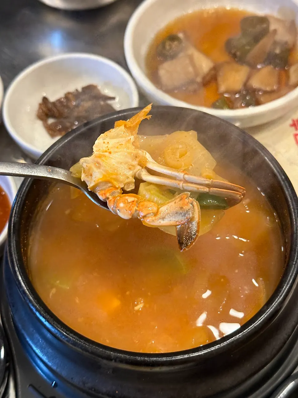 A piece of pork neck dipped in myeolchi-jeot