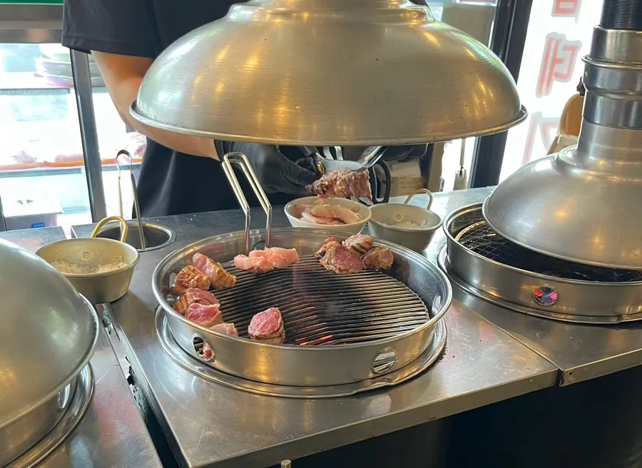 Select pork neck grilling over charcoal