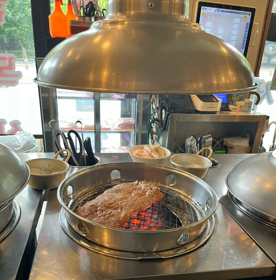 Meat on the charcoal grill with the full table spread