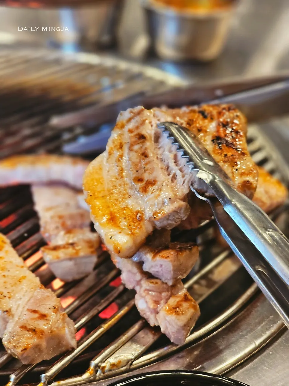 Pre-grilled pork belly placed on the tabletop grill