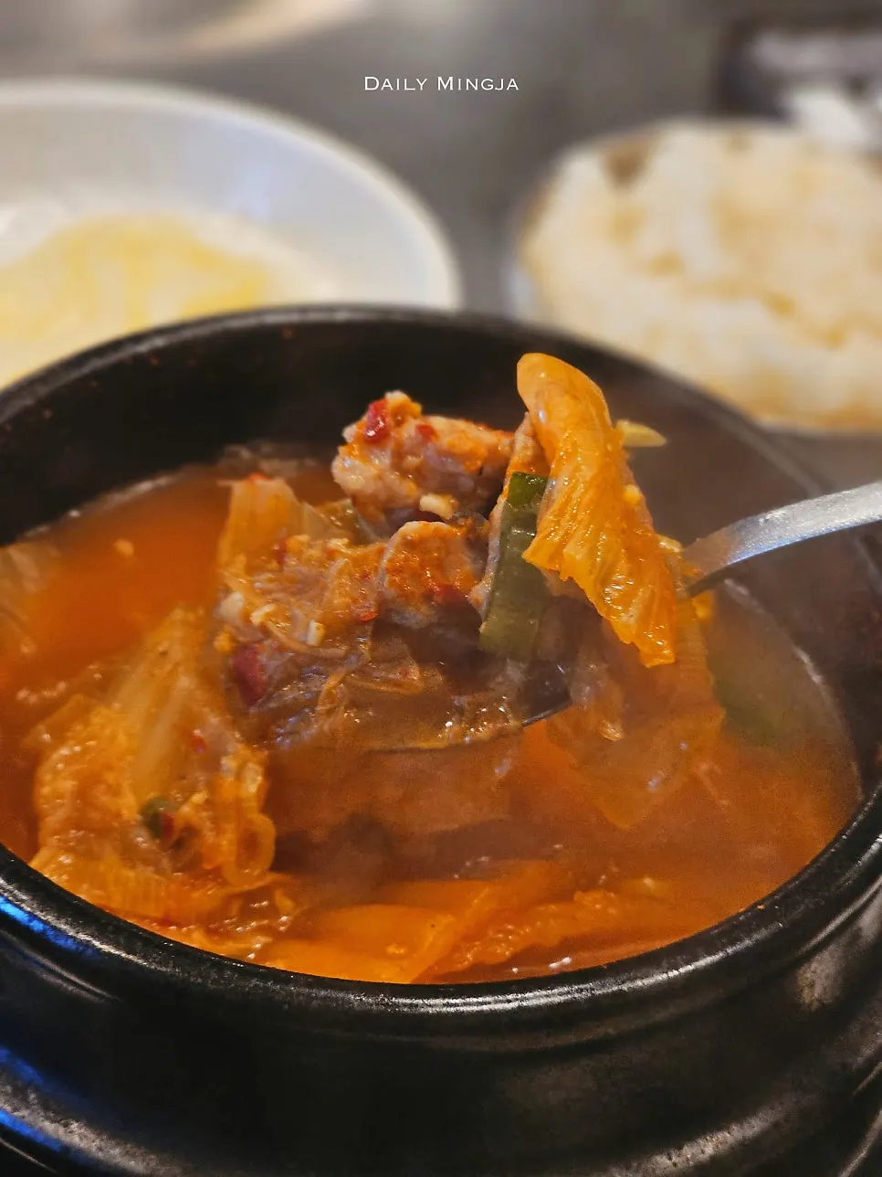 Meat and tofu inside the kimchi stew