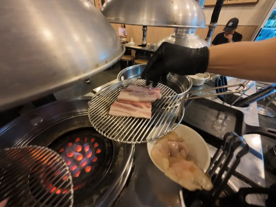 Pork belly sizzling over the charcoal