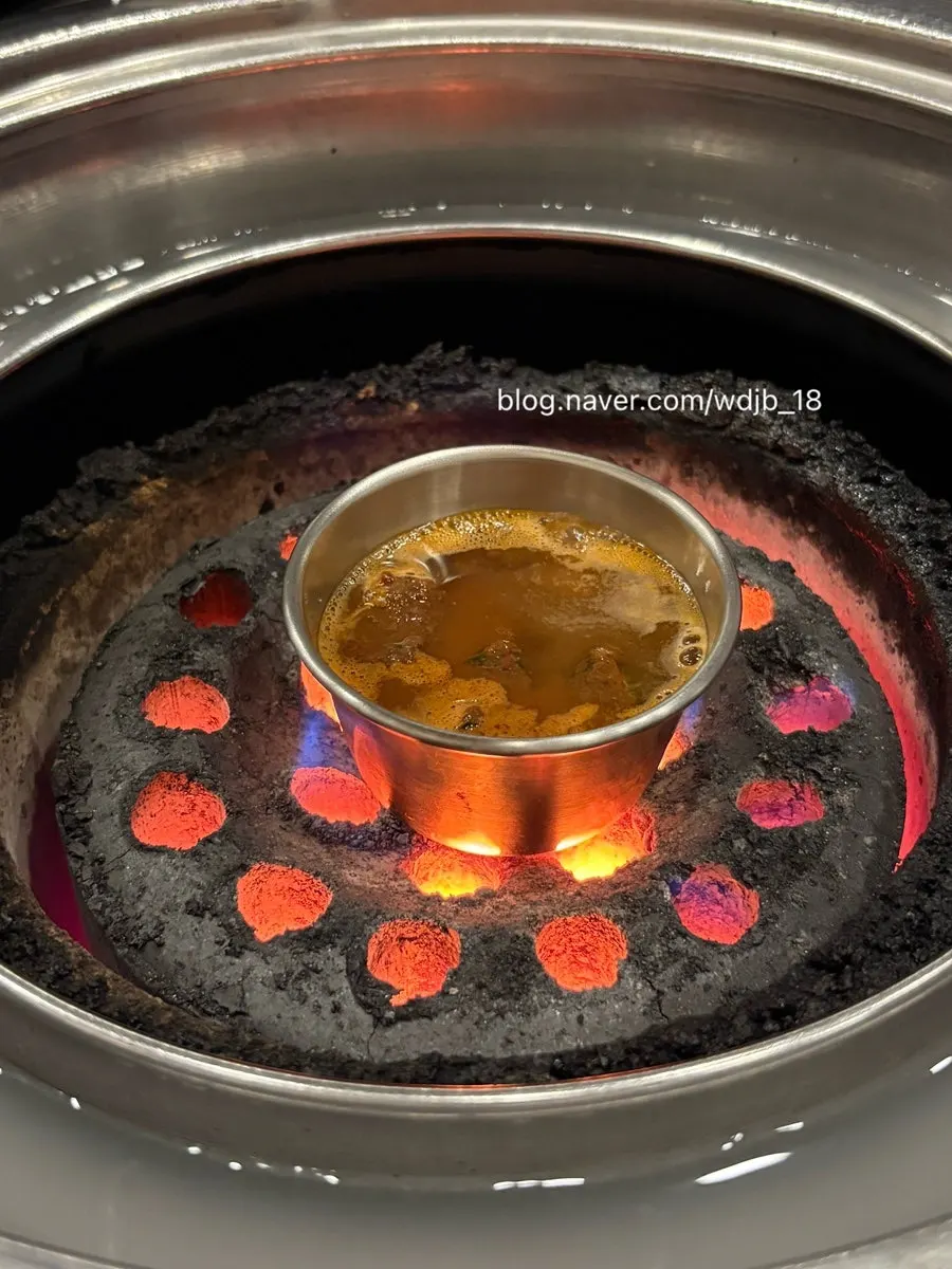A dish of salted anchovy sauce placed over the charcoal grill