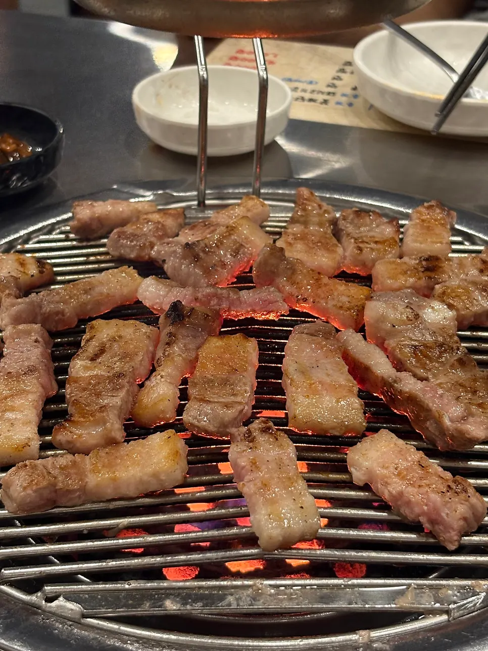 Pork belly cooking on the grill