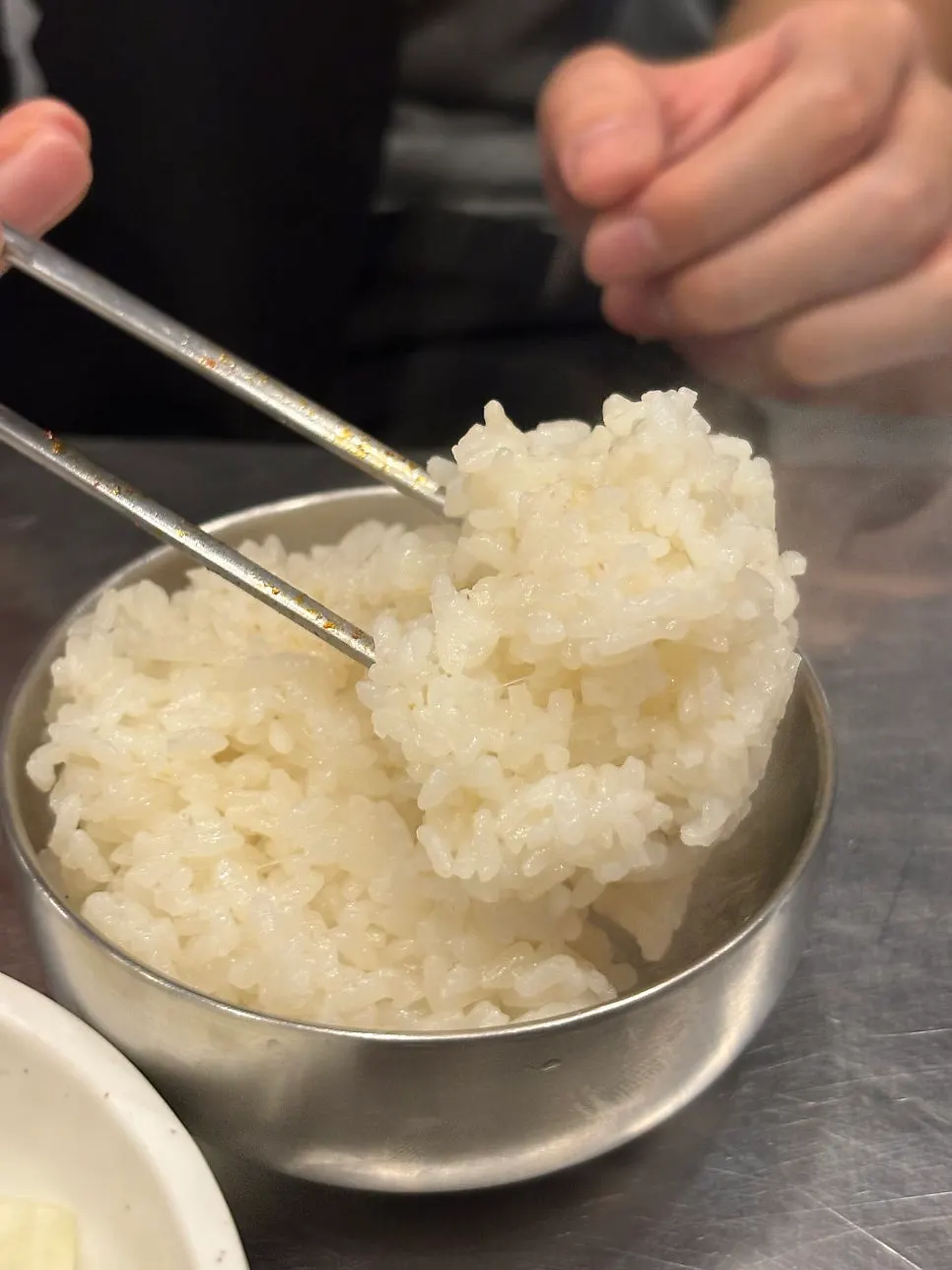 A bowl of rice served alongside the meat