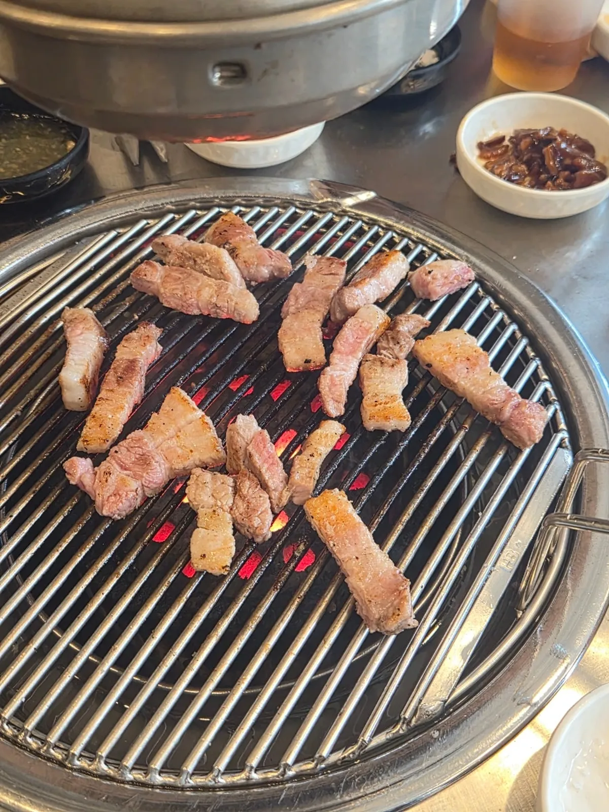 A full spread with kimchi jjigae and steamed rice alongside the meat