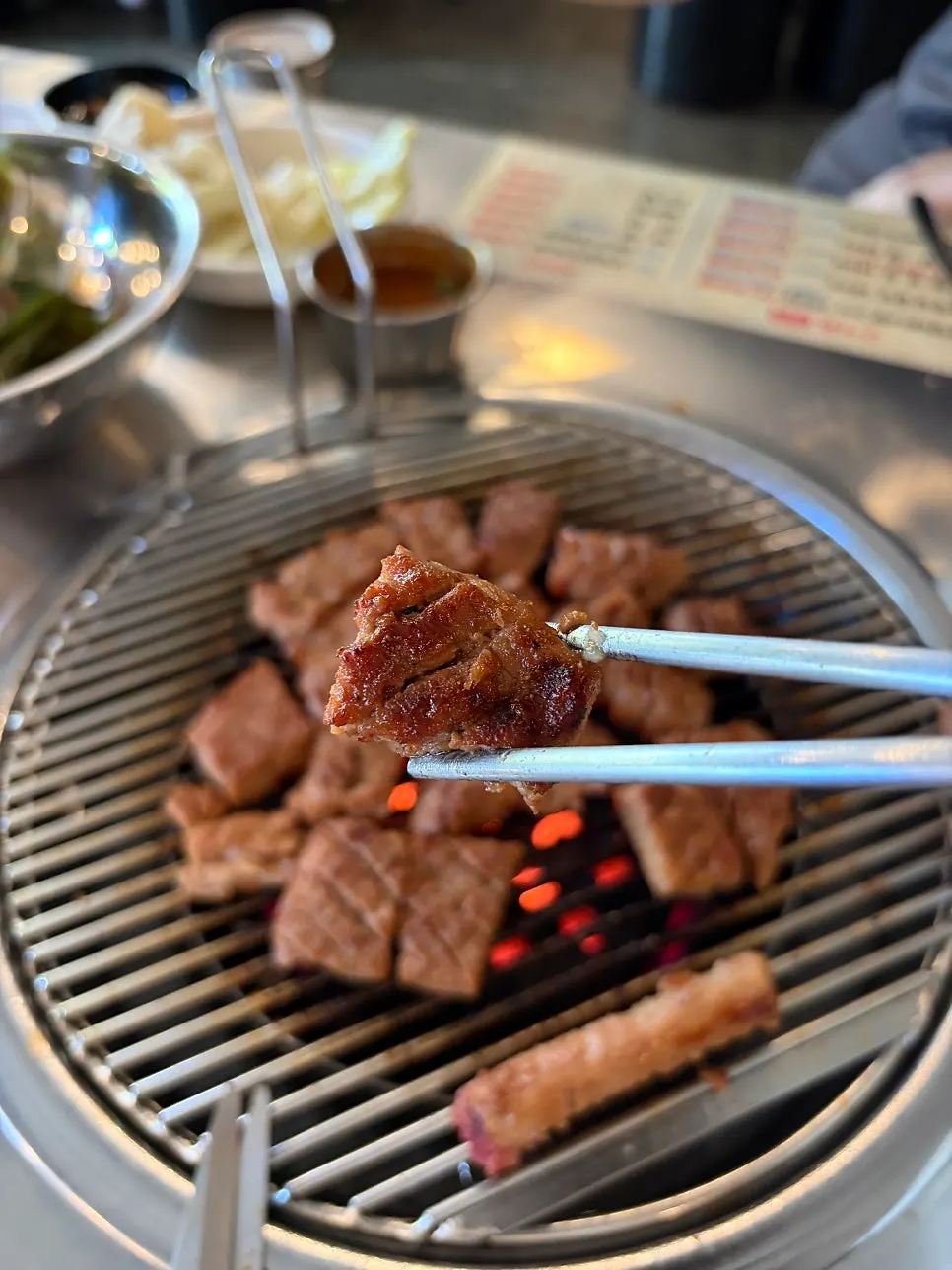Sauce-soaked pork skewer being grilled