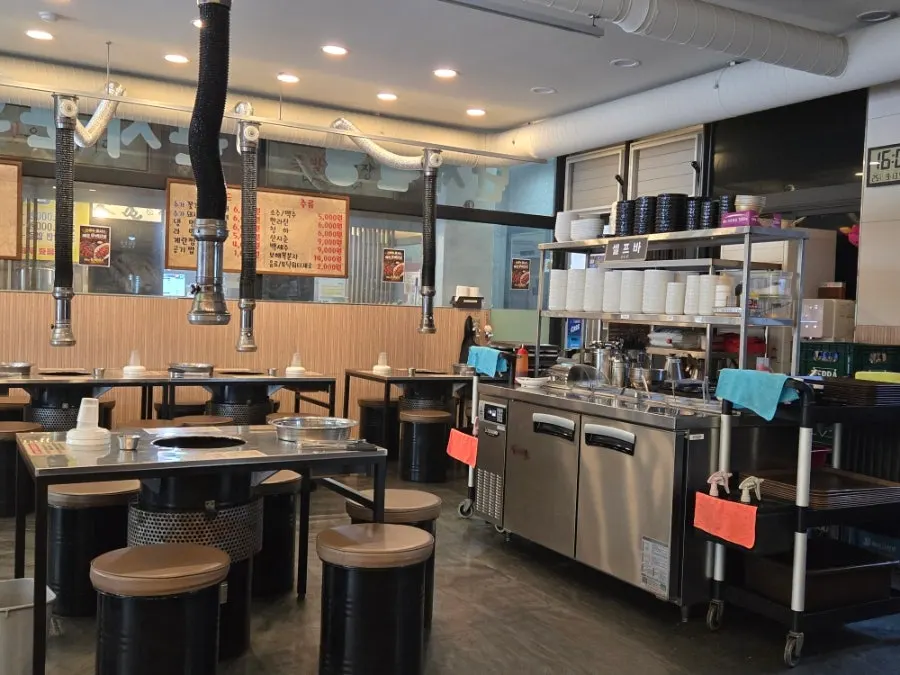 Seating at Tannae Paju Main Branch with a charcoal grill plate set up