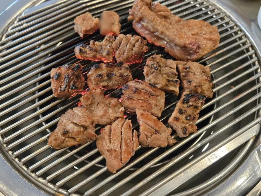 Marinated pork picking up smoky flavor from the charcoal