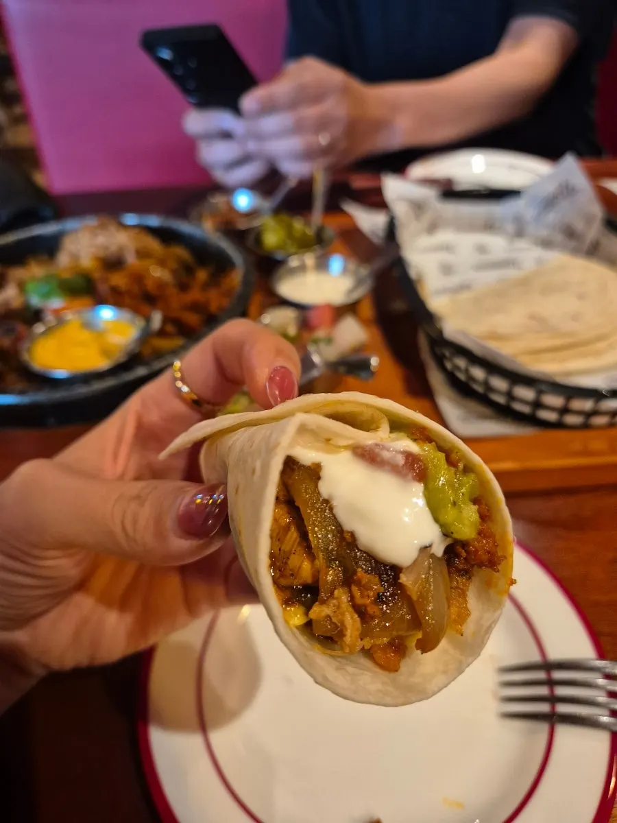 Wrapping meat and sauce into a tortilla