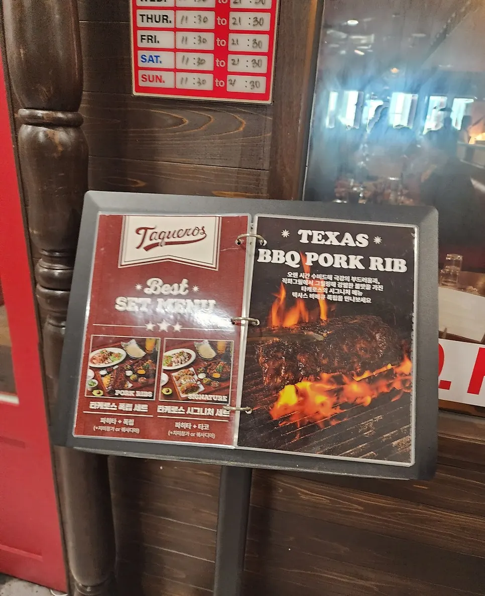 Red-roofed entrance and Taqueros sign