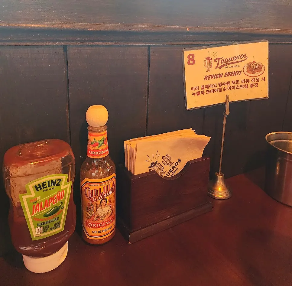 Hot sauce and jalapeño ketchup on the table