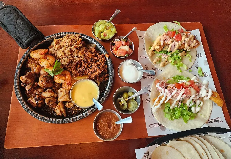 Chicken, shrimp, and beef on a sizzling platter