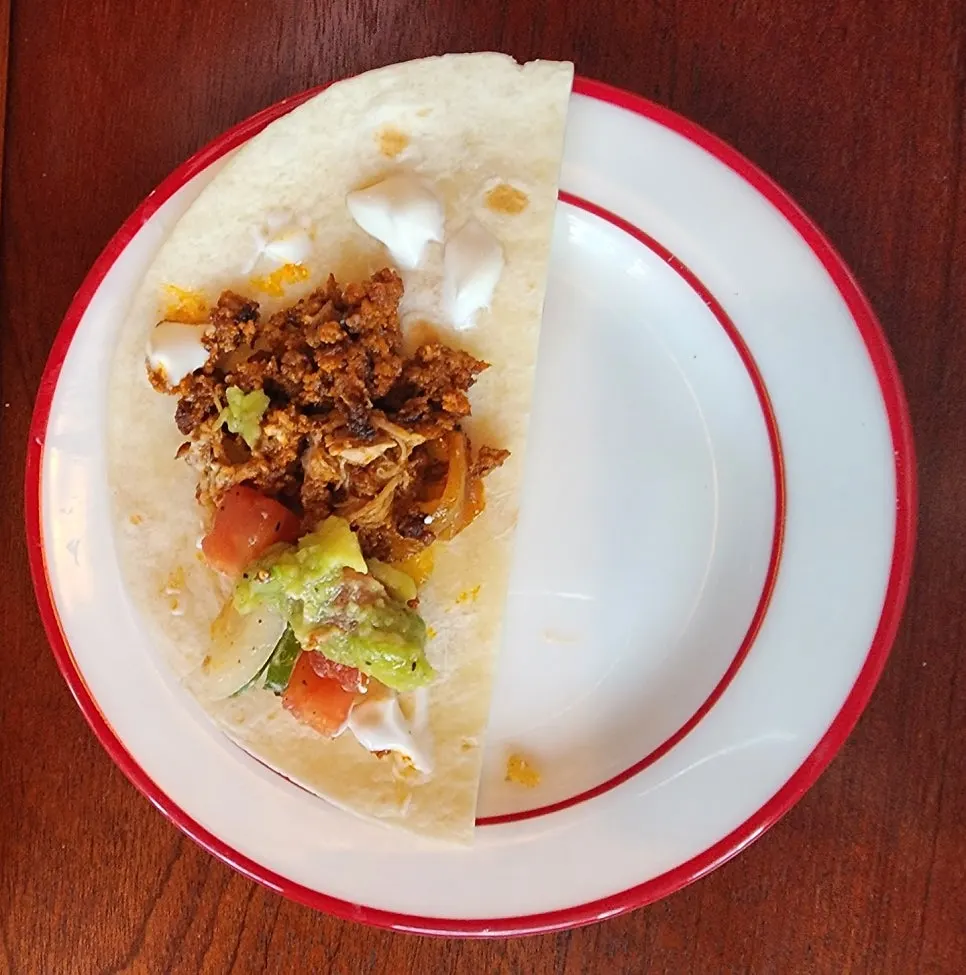 Tacos topped with salsa sauce and vegetables