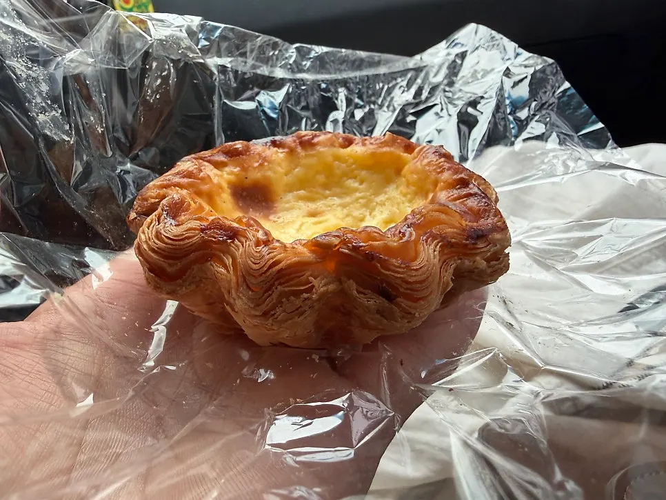 Cross-section of the egg tart showing crisp pastry and moist filling