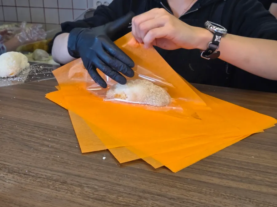 Fruit mochi being wrapped for takeout at Tareudang