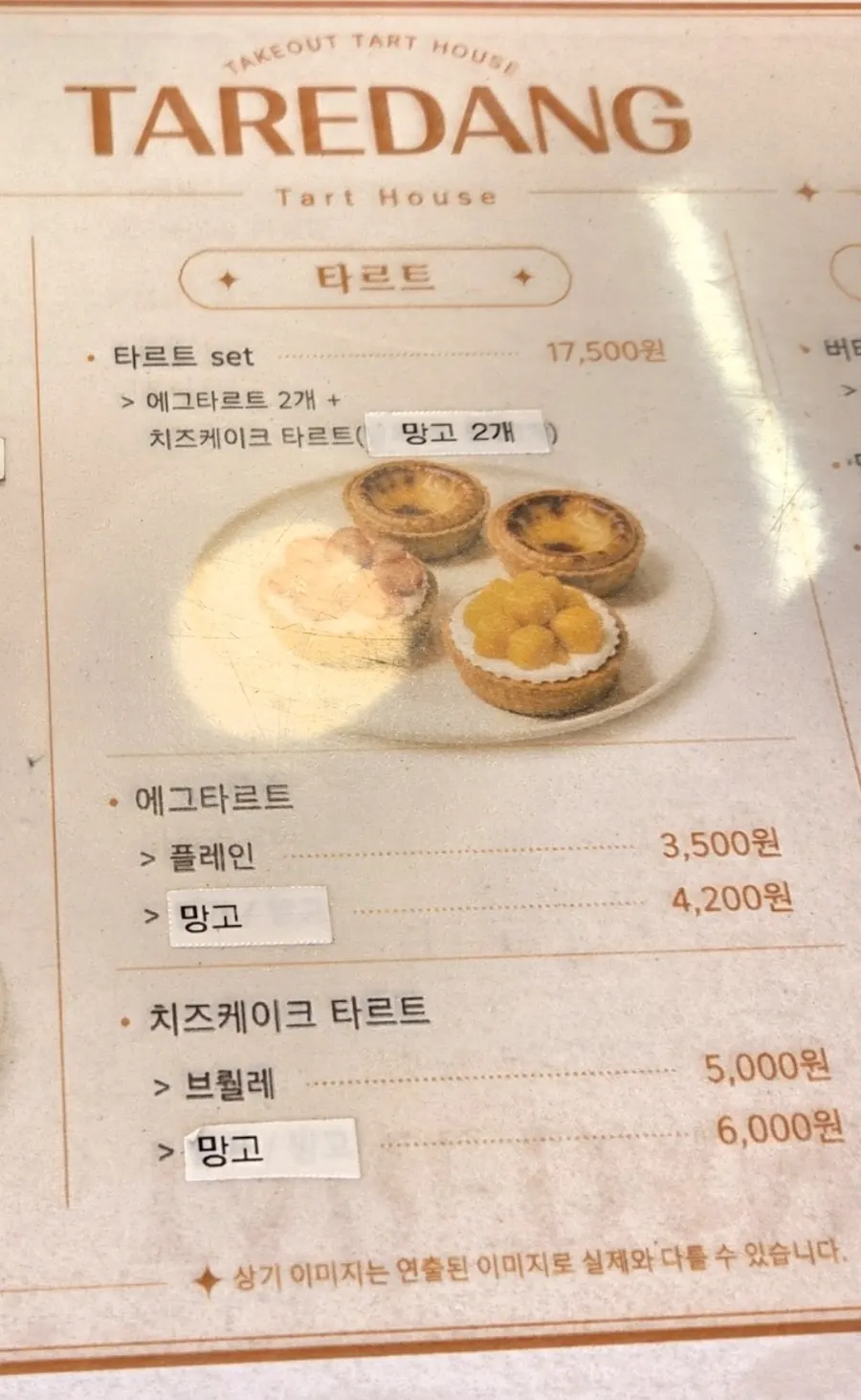 Menu board for Tareudang's egg tarts and cheesecake tarts