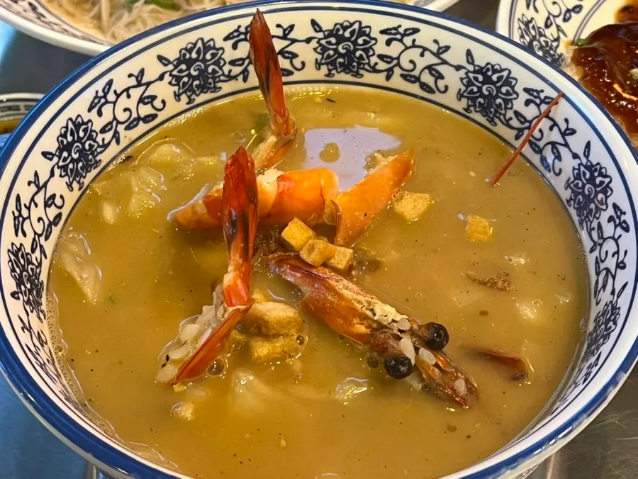 A bowl of Ttasijia shrimp gukbap topped with shrimp