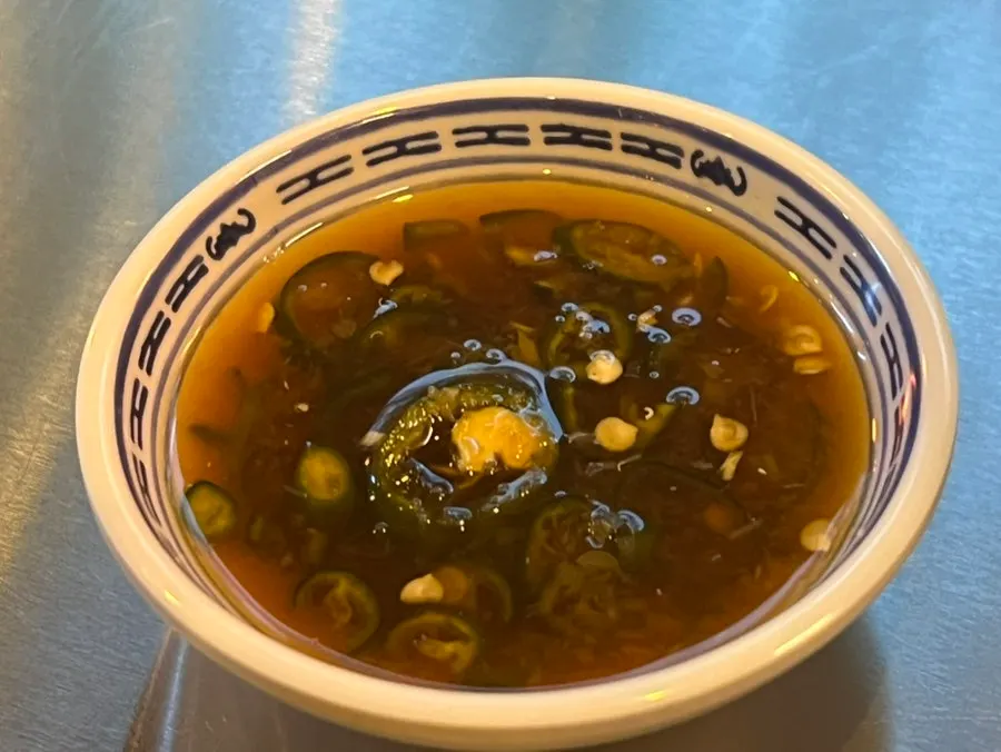 Chili-soy dipping sauce served alongside the fried noodles