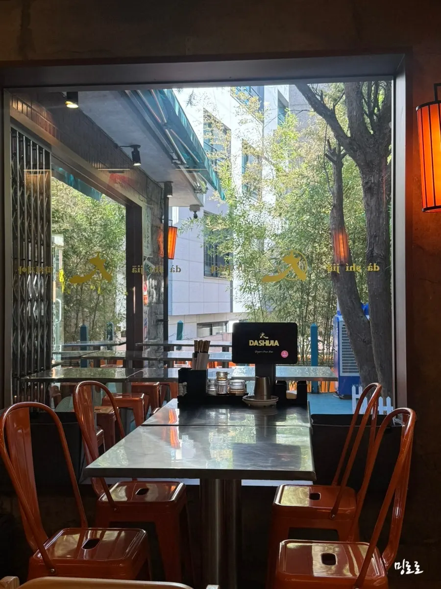 Softly lit dining hall seating at Ttasijia Yeonnam