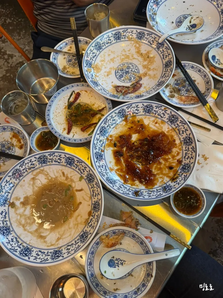 An empty plate that once held cereal shrimp