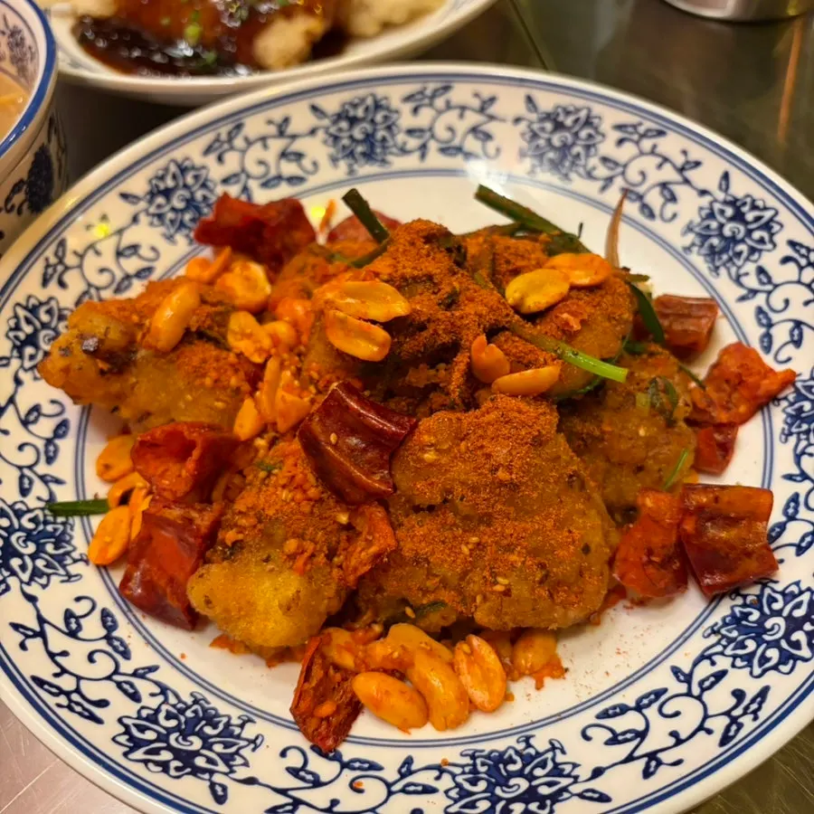 Mala chicken topped with mala powder and fried chili peppers