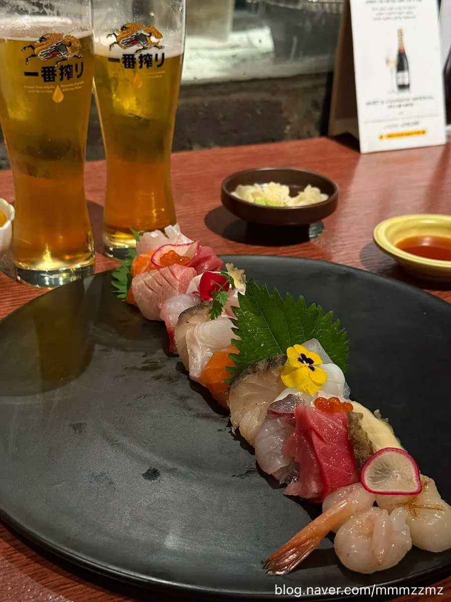 Plating of tuna, salmon, abalone, and sweet shrimp sashimi