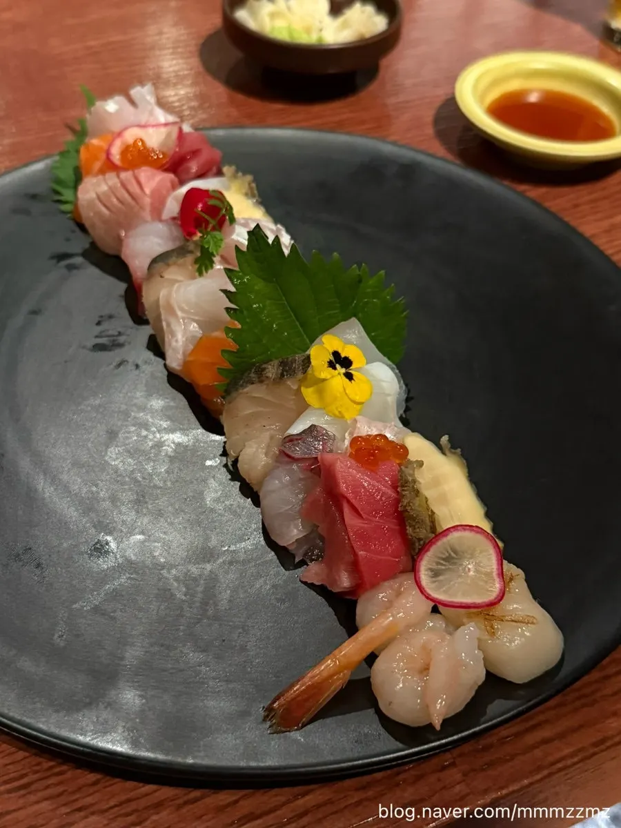 Table spread with sashimi and charcoal-grilled dishes