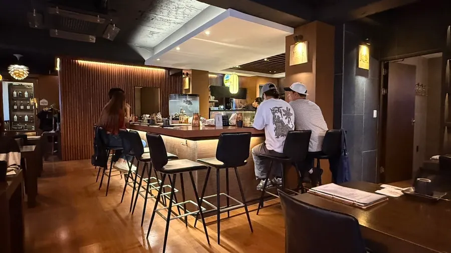 TATSU SUSAN's interior with wood-toned walls and low lighting