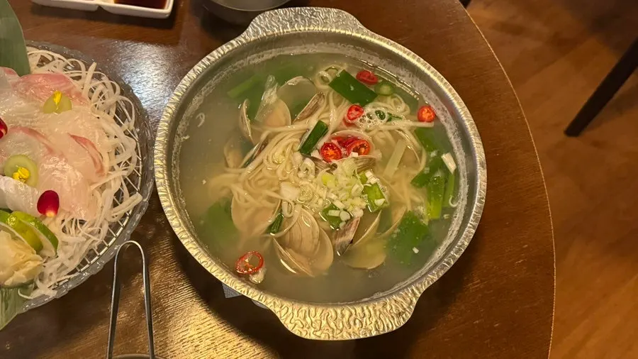Thick-cut halibut sashimi laid over shredded radish