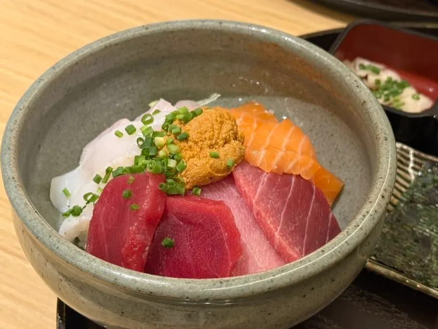 A thick piece of sashimi served with wasabi