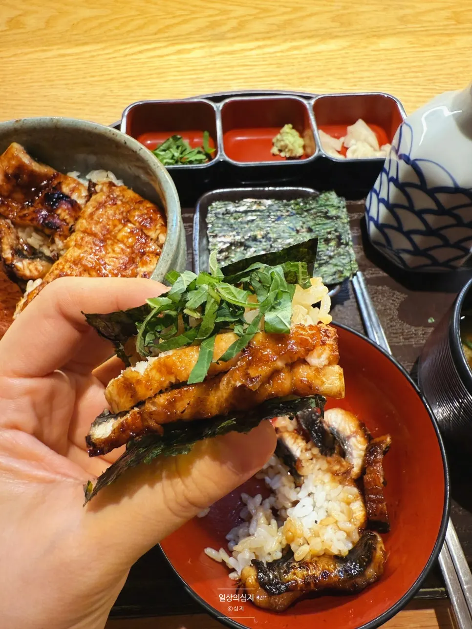 Seaweed wrap topped with two pieces of eel