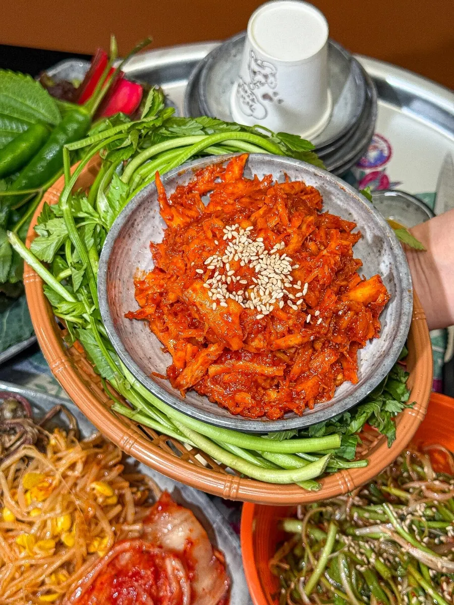Side dishes from the Deodeok Han-sang set and a plate of minari