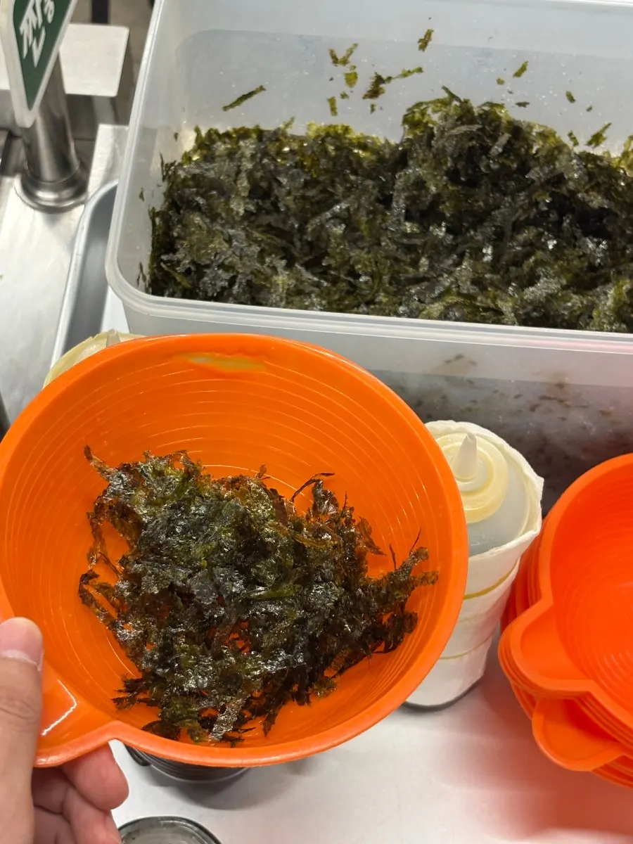 Kimchi, gochujang, and sesame oil laid out at the self-bar