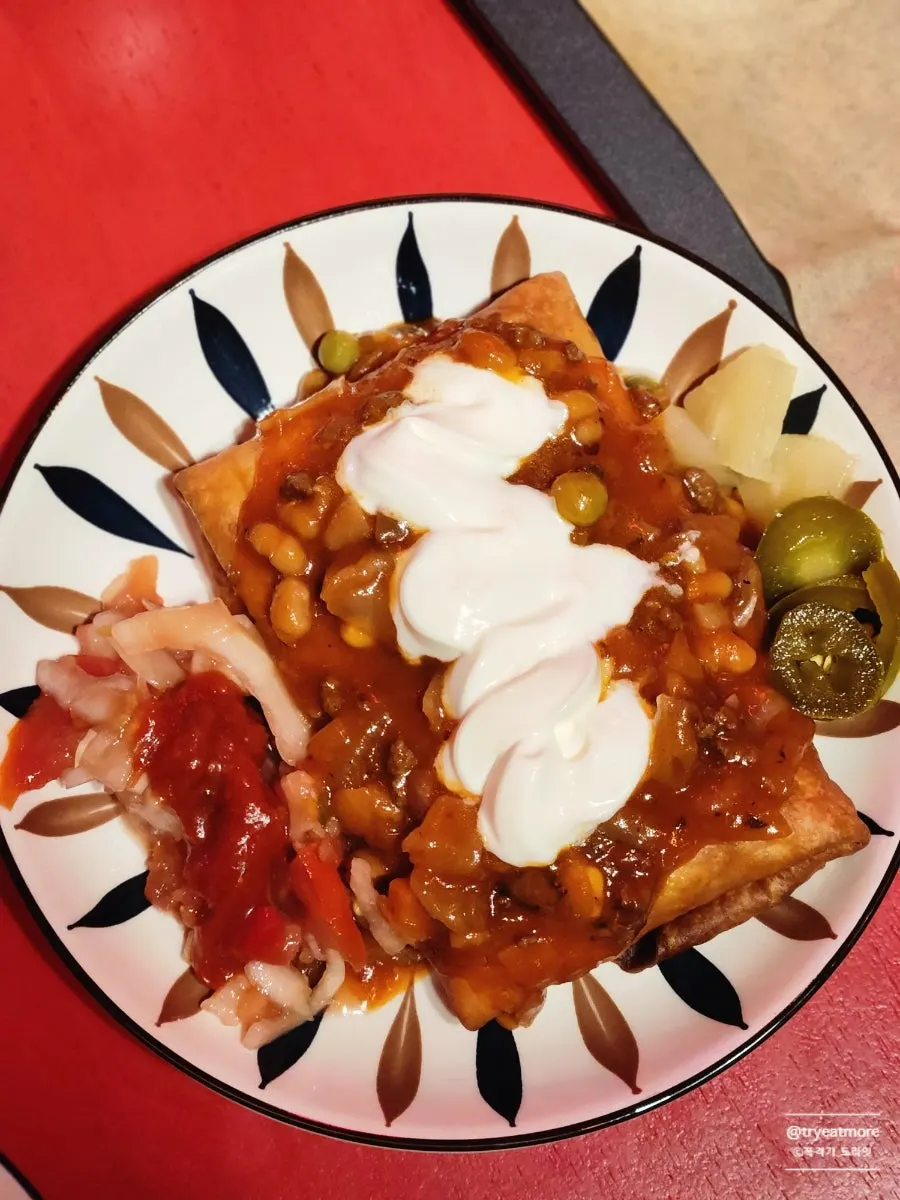 A taco plate served with cream cheese and jalapeños