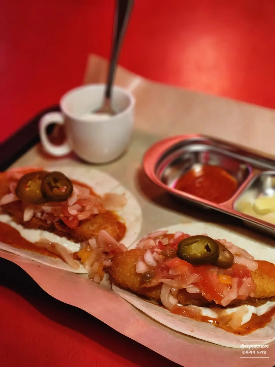 A fish taco topped with fried fish