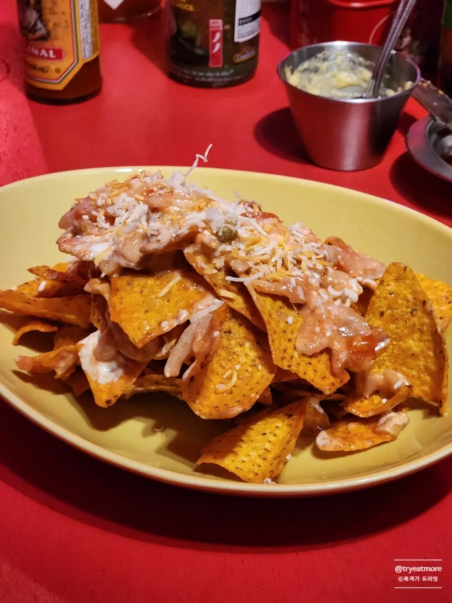 A plate of loaded doritos topped with onions