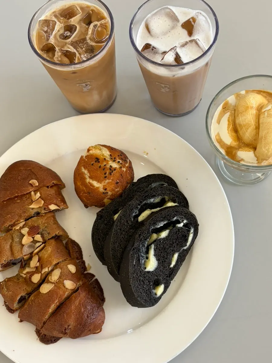 Sweet potato pie, squid ink roll cheese bread, mocha chewy bread, and coffee