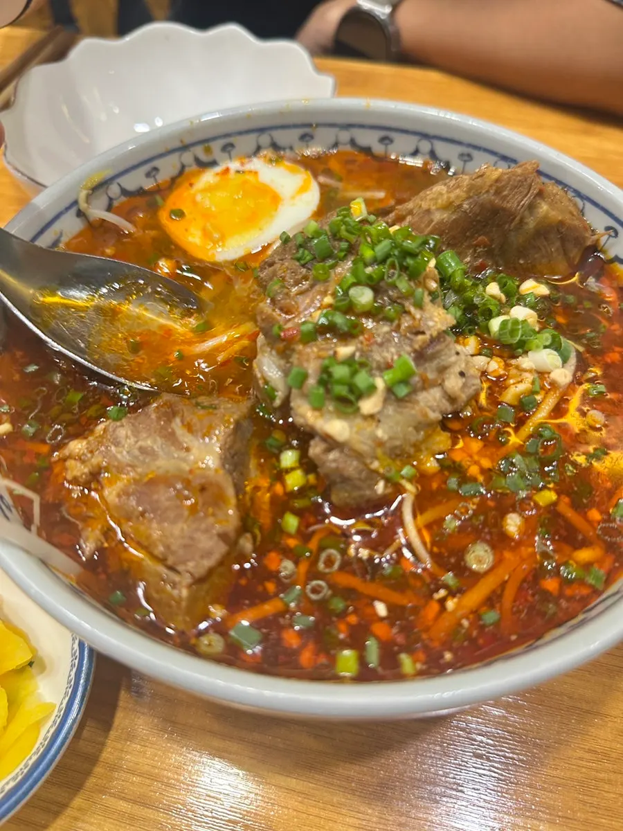 Meat pulled off the bone from the pork bone rice noodle soup
