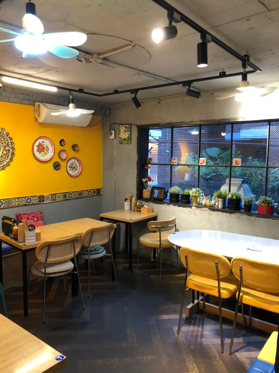Thanon55 interior decorated with yellow walls and Thai props