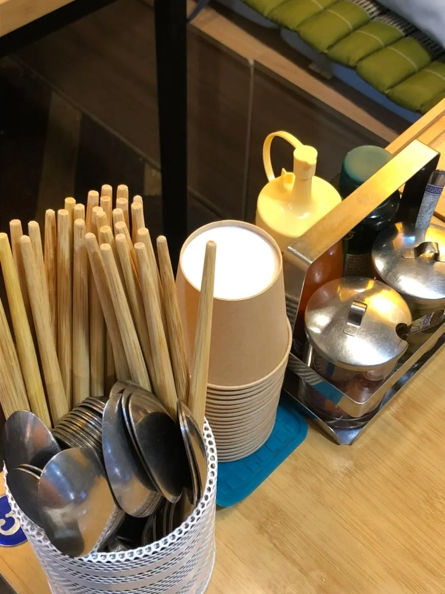 Table at Thanon55 set with utensils and sauces