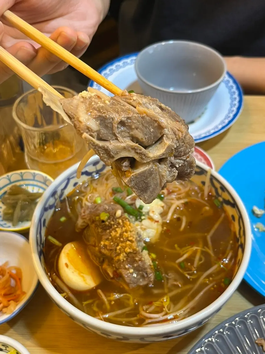 Spicy broth of the Thai-style gamjatang rice noodle soup