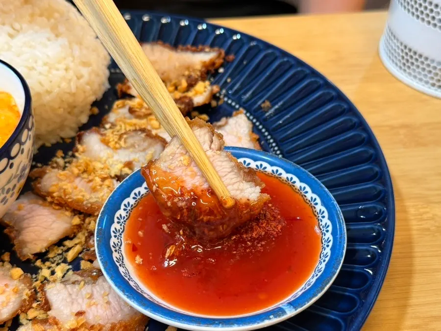 Close-up of crispy fried pork jowl mu thod curry